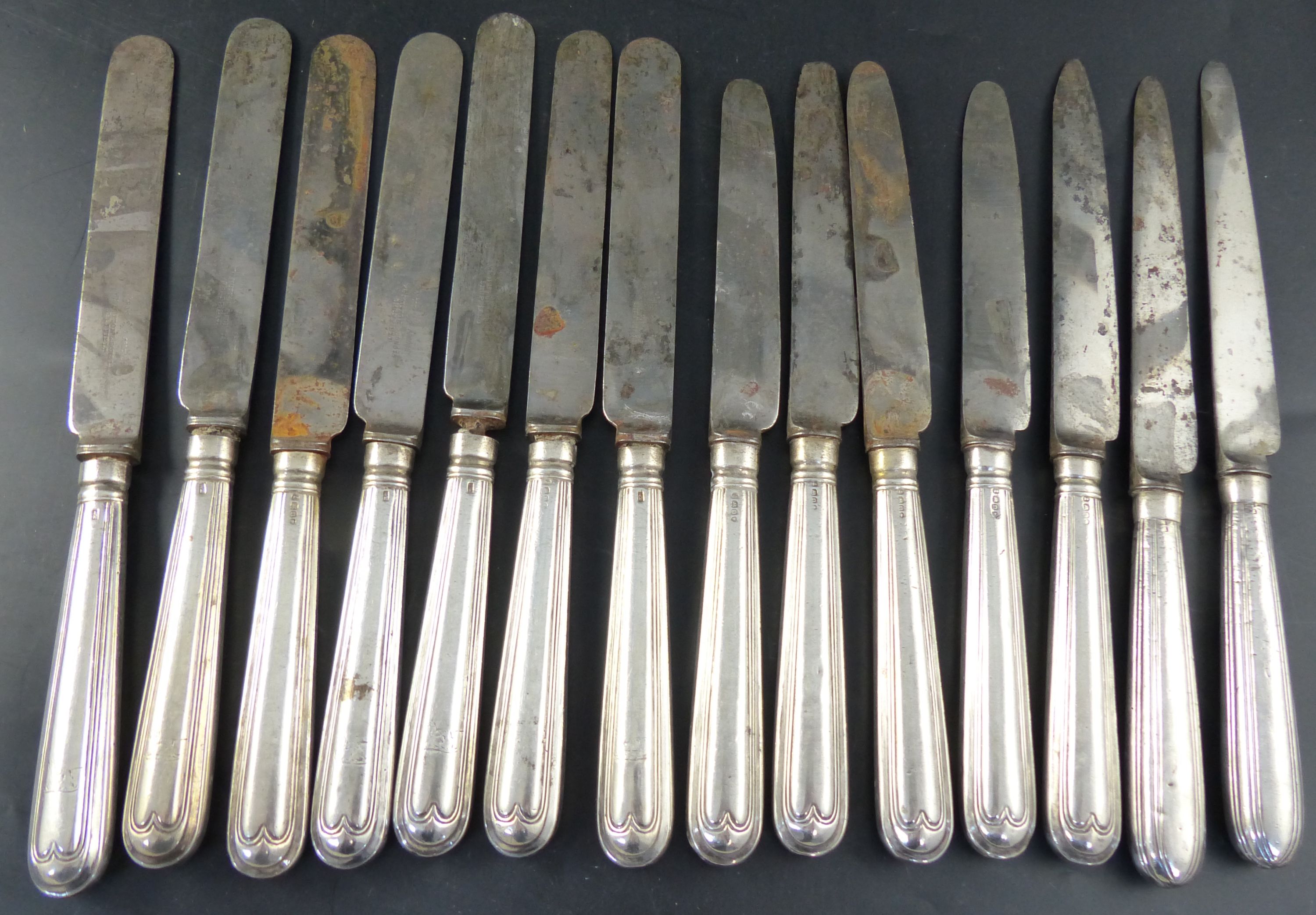 A set of twelve George IV silver handled thread pattern table knives,